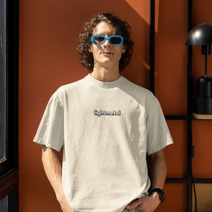 Corporate Beige - Person wearing a light-colored t-shirt with 'lightmetal' text, standing against an orange wall.