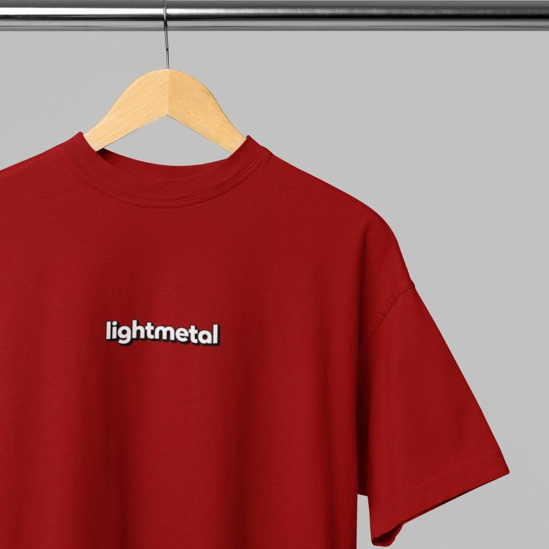 Primal Red - t-shirt with 'lightmetal' logo on a wooden hanger against a gray background