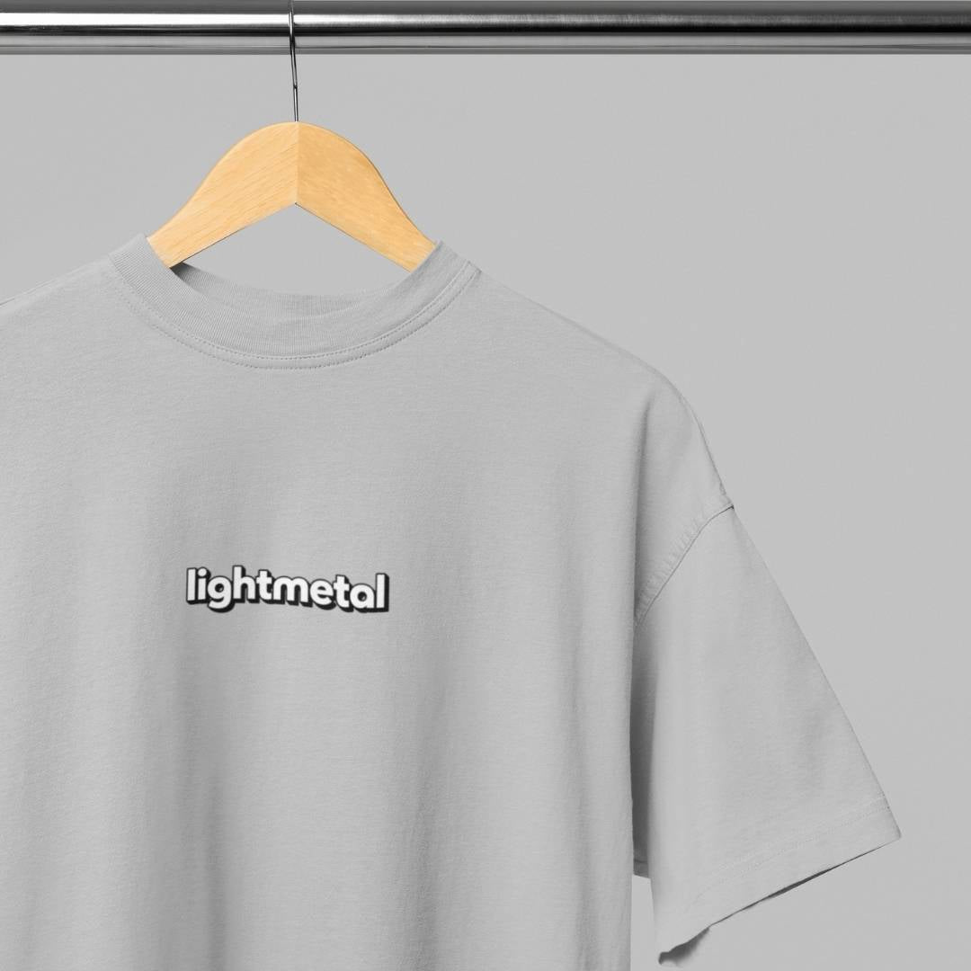 Stealth Gray - t-shirt with 'lightmetal' logo on a wooden hanger against a gray background